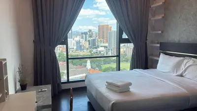 a hotel room with a bed and a large window at KL Sky Suite By Opus Residence in Kuala Lumpur
