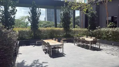 a patio with tables and chairs in a building at KL Sky Suite By Opus Residence in Kuala Lumpur