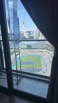 a view of a soccer field from a window at KL Sky Suite By Opus Residence in Kuala Lumpur