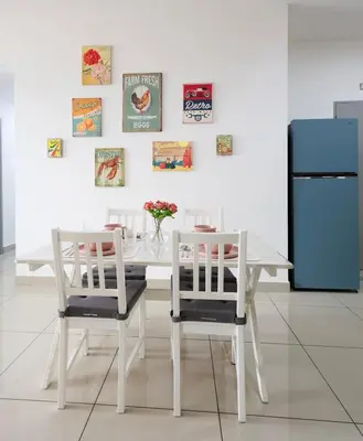 a white dining room table with two chairs and a refrigerator at Kuala Lumpur M Vertica Retro 3BR with Car park in Kuala Lumpur