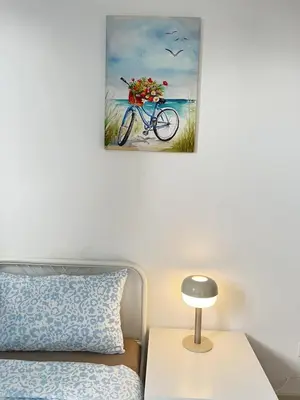 a bedroom with a bed and a painting of a bike on the beach at Kuala Lumpur M Vertica Retro 3BR with Car park in Kuala Lumpur