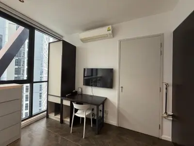 a room with a desk and a tv and a window at Metahome at Scarletz suites KLCC in Kuala Lumpur