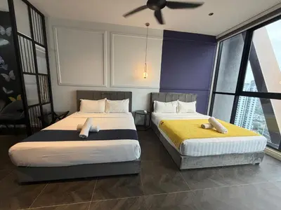 two beds in a bedroom with a ceiling fan at Metahome at Scarletz suites KLCC in Kuala Lumpur
