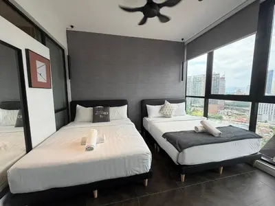a bedroom with two beds and a large window at Metahome at Scarletz suites KLCC in Kuala Lumpur