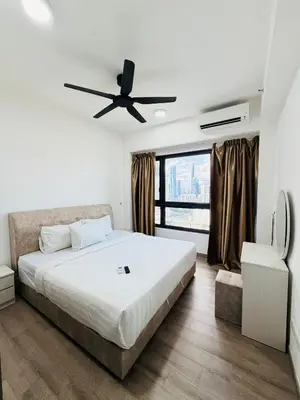 a bedroom with a bed and a ceiling fan at Agile Bukit Bintang TRX By Glanza Suites in Kuala Lumpur