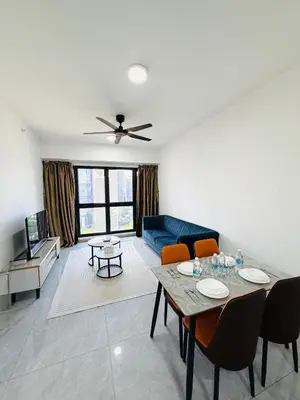 a living room with a table and a blue couch at Agile Bukit Bintang TRX By Glanza Suites in Kuala Lumpur