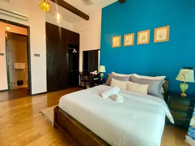 a large bed in a room with a blue wall at Opus Residence 1R1B Pinwu 118 view|Balcony|LRT in Kuala Lumpur