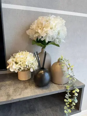 three vases with white flowers sitting on a shelf at Robertson 1R1B Pinwu Bkt Bintang|Chinatown|LRT in Kuala Lumpur