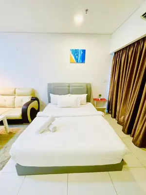 a bedroom with two beds and a couch at Mercu Summer suites KLCC by Classy in Kuala Lumpur