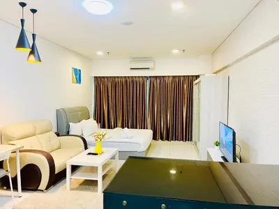 a living room with a couch and a table at Mercu Summer suites KLCC by Classy in Kuala Lumpur