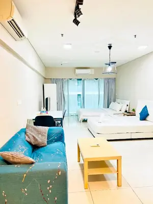 a living room with a couch and a table at Mercu Summer suites KLCC by Classy in Kuala Lumpur