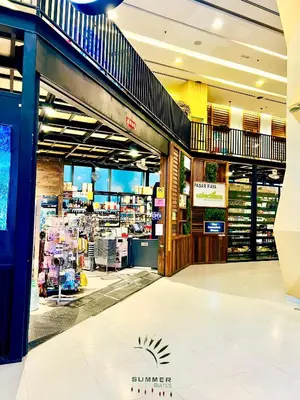 a shopping mall with a staircase in a store at Mercu Summer suites KLCC by Classy in Kuala Lumpur
