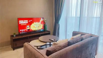 a living room with a couch and a flat screen tv at trion in Kuala Lumpur