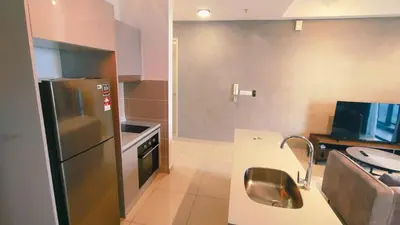 a kitchen with a stainless steel refrigerator and a sink at trion in Kuala Lumpur