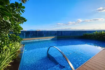 a swimming pool on top of a building at Eaton Residences KL City Center in Kuala Lumpur