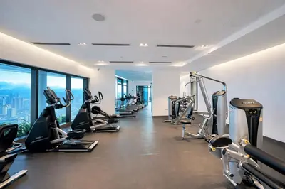a gym with treadmills and elliptical machines at Eaton Residences KL City Center in Kuala Lumpur