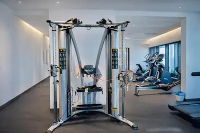 a gym with several tread machines in a room at Eaton Residences KL City Center in Kuala Lumpur