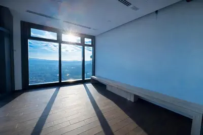 an empty room with a large window with a view at Eaton Residences KL City Center in Kuala Lumpur