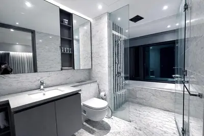 a bathroom with a toilet and a sink and a shower at Eaton Residences KL City Center in Kuala Lumpur