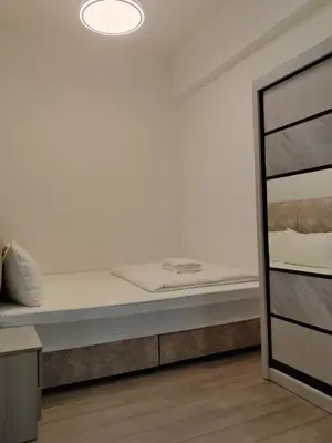 a bed in a room with a white wall at Agile Bukit Bintang Sleepy in Kuala Lumpur