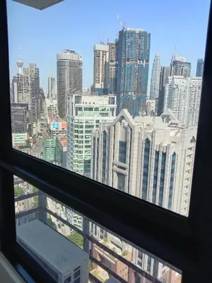 a view of a city skyline from a window at Agile Bukit Bintang Sleepy in Kuala Lumpur