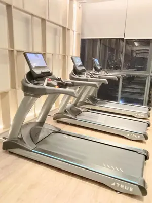 a treadmill with two cell phones on it at Agile Bukit Bintang Sleepy in Kuala Lumpur