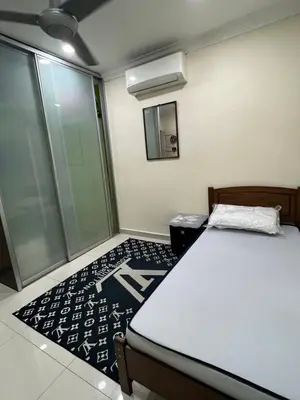 a bedroom with a bed and a mirror in it at Gombak Fatin Homestay in Kuala Lumpur