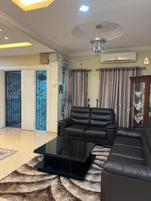 a living room with a couch and a table at Gombak Fatin Homestay in Kuala Lumpur