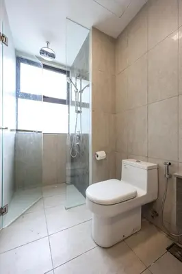 a bathroom with a toilet and a glass shower at Elegant Skyline Suite # Datum Jelatek near KLCC in Kampong Datok Keramat