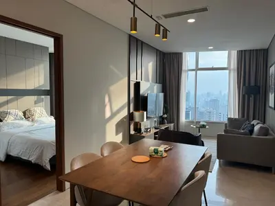 a room with a table and a bed and a bedroom at Tomato Homestay By Sky Suites Klcc in Kuala Lumpur
