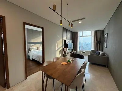 a room with a dining table and a bedroom at Tomato Homestay By Sky Suites Klcc in Kuala Lumpur
