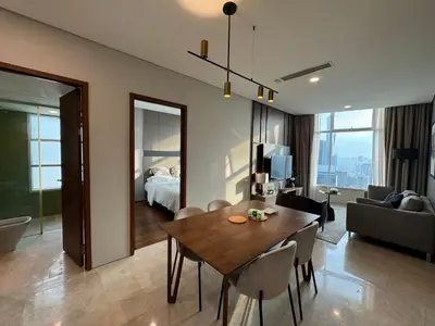 a living room with a dining table and a bedroom at Tomato Homestay By Sky Suites Klcc in Kuala Lumpur