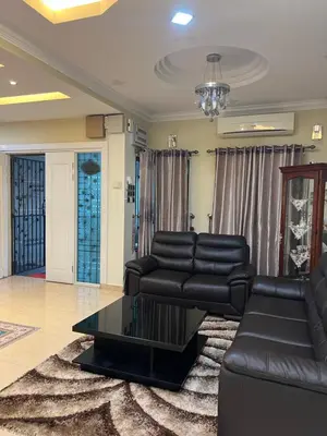a living room with a couch and a table at Gombak Fatin Homestay in Kuala Lumpur