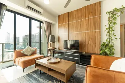 a living room with a tv and a couch and a table at The Premium Lofts Bukit Bintang in Kuala Lumpur