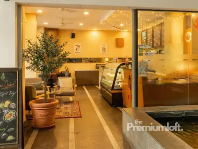 a restaurant with a potted tree in a room at The Premium Lofts Bukit Bintang in Kuala Lumpur
