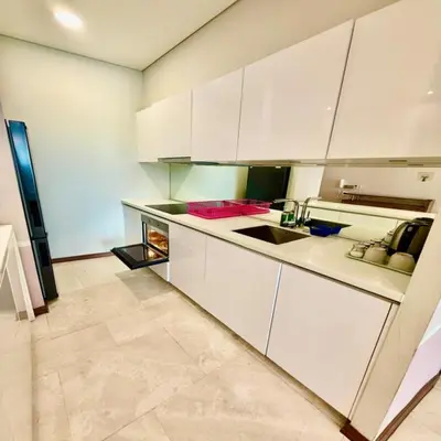 a kitchen with white cabinets and a sink at Sky suites klcc by sky view in Kuala Lumpur