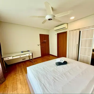 a bedroom with a white bed and a ceiling fan at Sky suites klcc by sky view in Kuala Lumpur