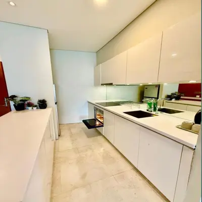 a kitchen with white counters and white cabinets at Sky suites klcc by sky view in Kuala Lumpur