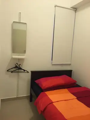 a bedroom with a bed and a tv on the wall at The Forum Kuala Lumpur in Kuala Lumpur