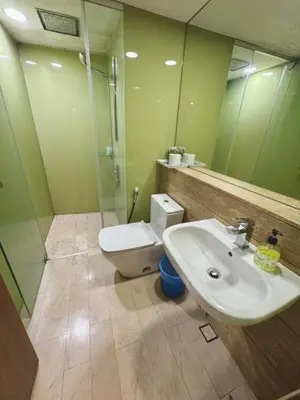 a bathroom with a sink and a toilet and a mirror at Vortex suites Near Klcc By I&J in Kuala Lumpur