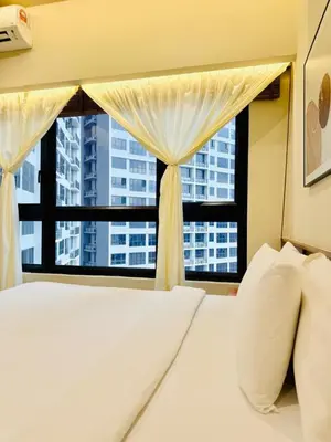 a bedroom with a bed and a large window at The Agile Residence By Signature in Kuala Lumpur
