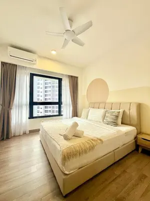 a bedroom with a large bed with a ceiling fan at The Agile Residence By Signature in Kuala Lumpur