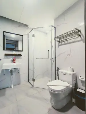 a bathroom with a shower and a toilet and a sink at Agile suits of Kuala Lumpur in Kuala Lumpur