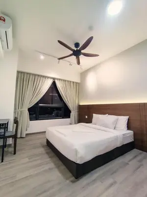a bedroom with a bed with a ceiling fan at Agile suits of Kuala Lumpur in Kuala Lumpur