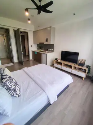 a bedroom with a large bed with a ceiling fan at Agile suits of Kuala Lumpur in Kuala Lumpur