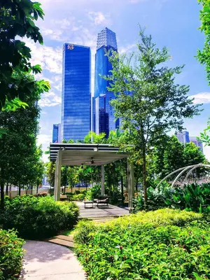 a bench in a park with a city in the background at Agile suits of Kuala Lumpur in Kuala Lumpur