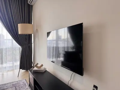 a living room with a flat screen tv on a wall at 3 Bedrooms KLCC View PlazaRah,Kg Baru next to Rembayung in Kuala Lumpur