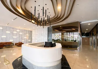 a lobby of a hotel with a large chandelier at LUXORA SUITE's REIZZ RESIDENCE in Kuala Lumpur