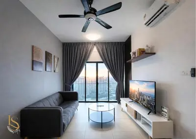 a living room with a couch and a tv at LUXORA SUITE's REIZZ RESIDENCE in Kuala Lumpur