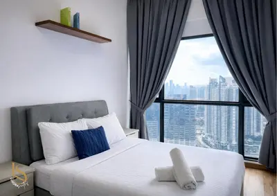 a bedroom with a white bed with a large window at LUXORA SUITE's REIZZ RESIDENCE in Kuala Lumpur